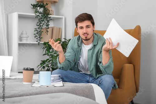 Stressed young man with pap...
