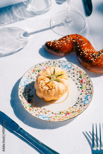 Elegant table setting with gourmet pastry and sesame bread twist