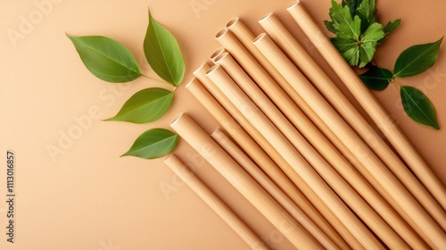 Bamboo straws presented in eco-friendly packaging alongside decorative green leaves, highlighting a clean and sustainable aesthetic