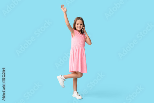 Happy little girl talking b...