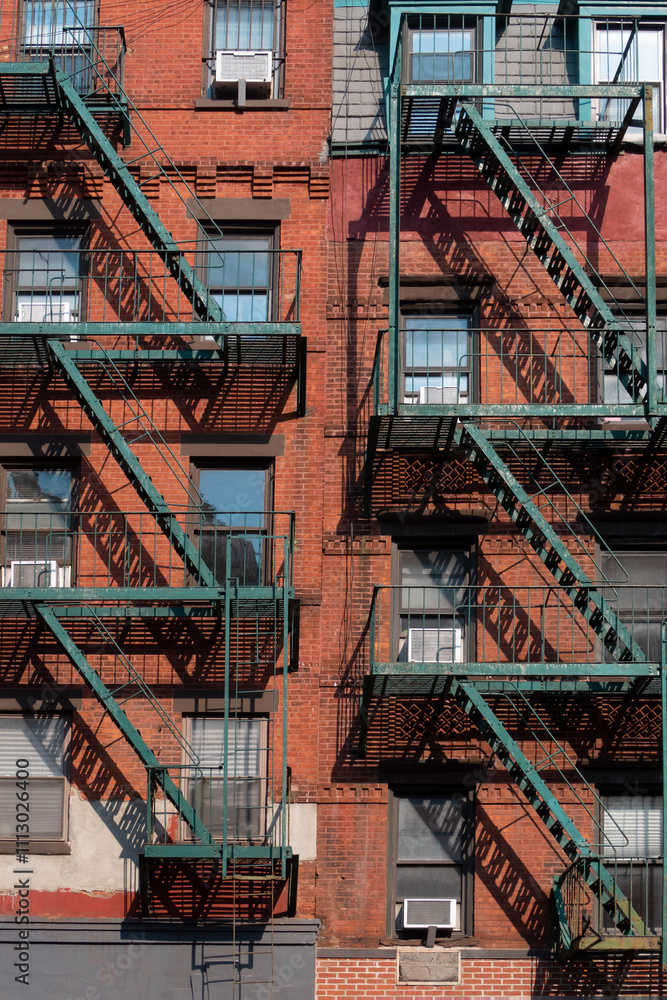 Red bulding facade with green fire escape stairs at Manhattan Red bulding facade with green fire escape stairs at Manhattan