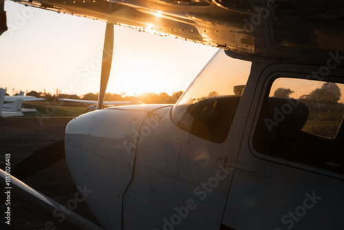 Side On View of  Light Training  Aircraft At Sunset   photo