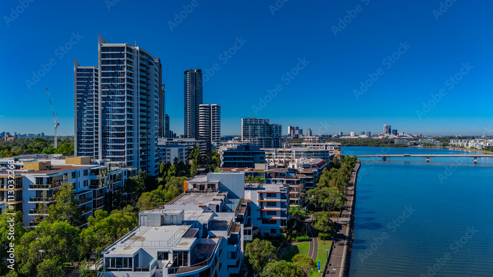 Fototapeta premium Panorama Aerial view above Rhodes with views to Meadowbank and Olympic park and Wentworth Point and Concord West with Parramatta River in Sydney NSW Australia