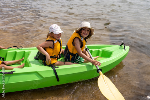 Dad and his children's going a kayak ride. photo