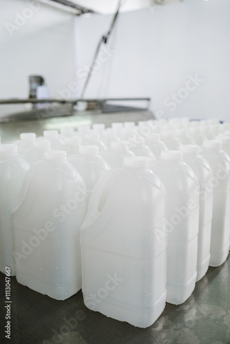 White plastic gallons on a work table photo