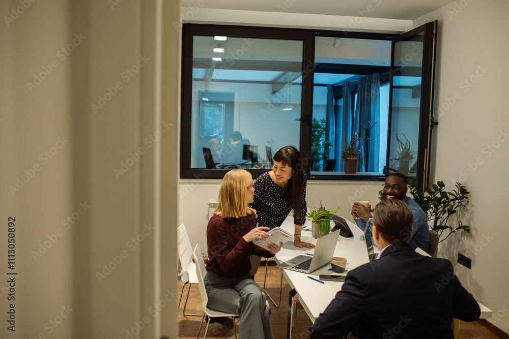 Diverse colleagues talking in modern office sitting space Diverse colleagues talking in modern office sitting space