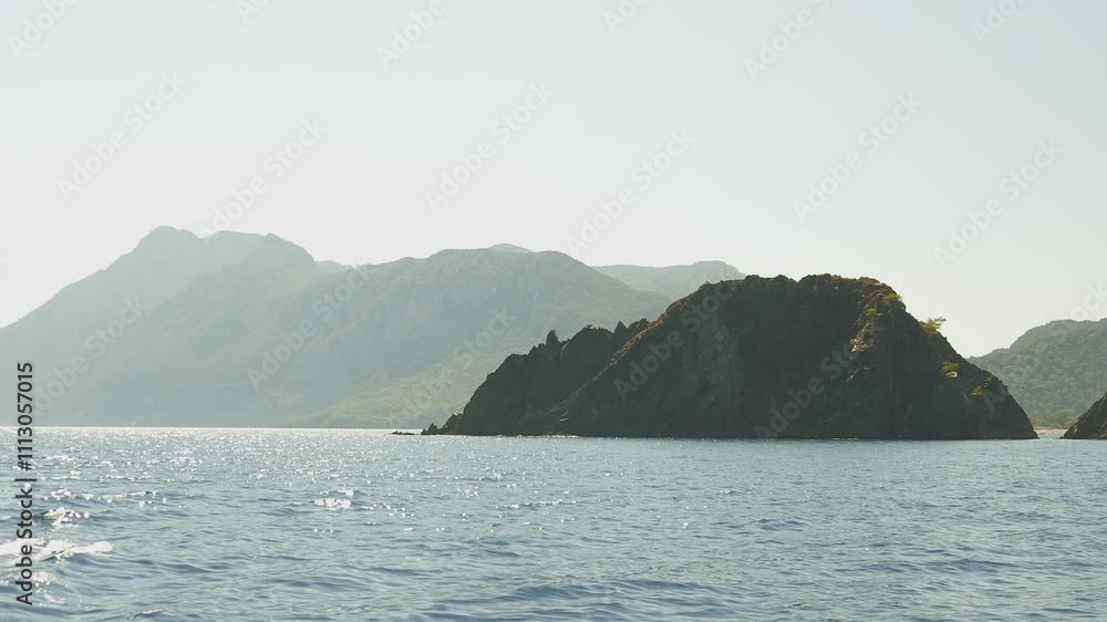 A breathtaking view of beautiful mountains and a scenic island captured from a yacht in Kemer, Turkey. A breathtaking view of beautiful mountains and a scenic island captured from a yacht in Kemer, Turkey.