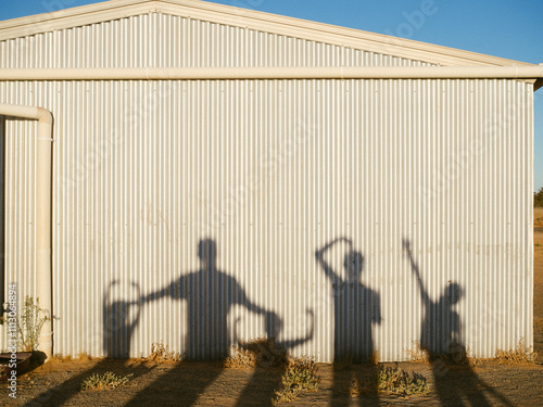 Family shadow on shed photo