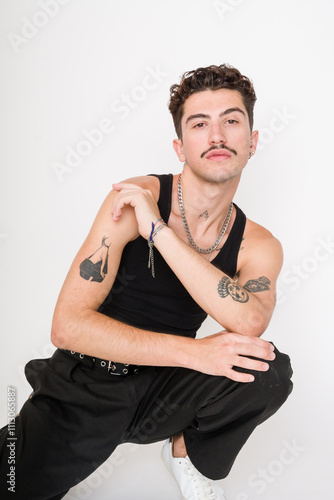 man with tattoos posing in studio photo