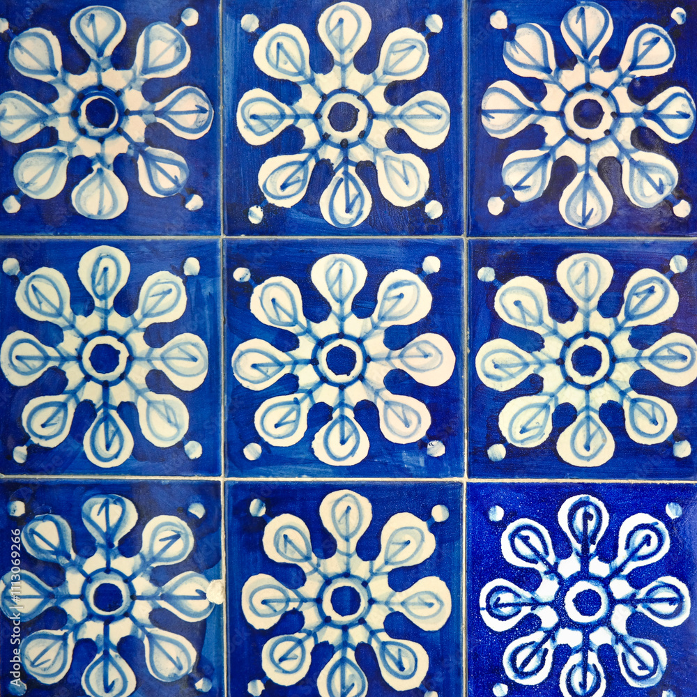 Fragment of building wall with colorful ceramic wall tiles, Azulejo close up. Abstract decorative background, textured ornate pattern for design or backdrop. Traditional ornate Portuguese architecture Fragment of building wall with colorful ceramic wall tiles, Azulejo close up. Abstract decorative background, textured ornate pattern for design or backdrop. Traditional ornate Portuguese architecture