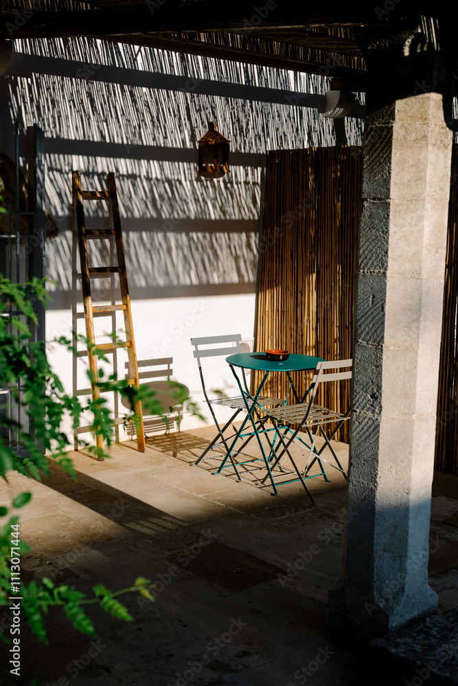 A small table illuminated by sunlight in an outdoor living room A small table illuminated by sunlight in an outdoor living room