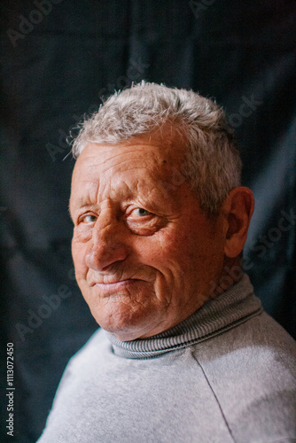 Portrait of an elderly man on a black background. photo