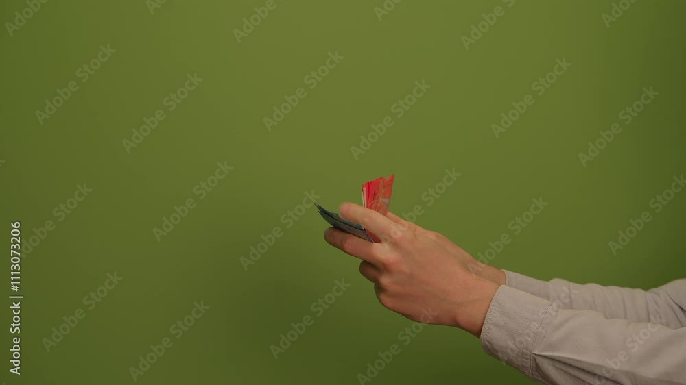Handing Over an Object in Front of a Bright Green Background for Captivating Imagery Handing Over an Object in Front of a Bright Green Background for Captivating Imagery