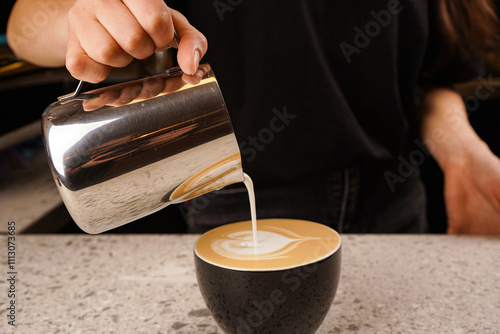 Close-up of the process of brewing cappuccino coffee with thick milk foam from the cappuccinatore. photo