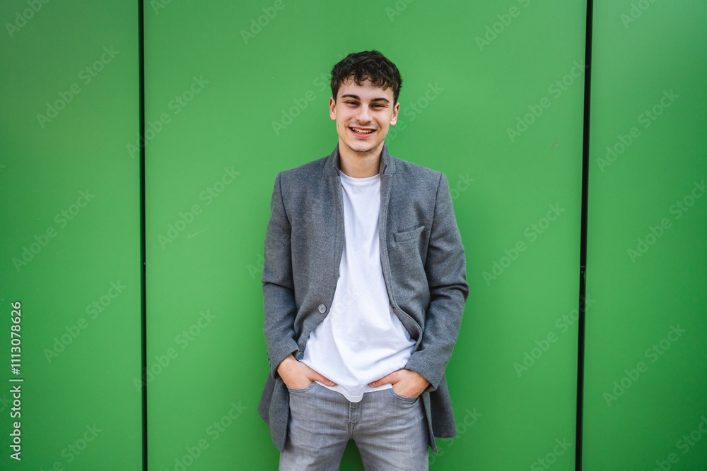 Portrait of beautiful young adult man stand behind green wall Portrait of beautiful young adult man stand behind green wall