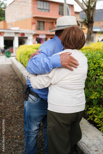 Older friends giving each other a hug photo