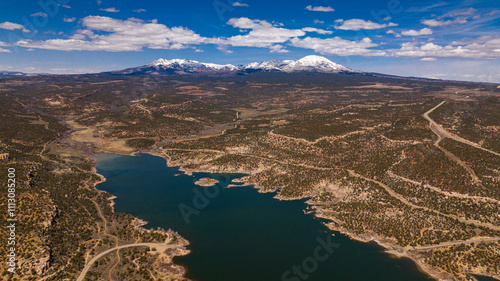 MARCH 2024, BLANDING, UTAH - USA -  near Blanding shows Recapture Reservoir Lake with snow capped Abajo Mountains in background - an aerial view in early spring Utah photo