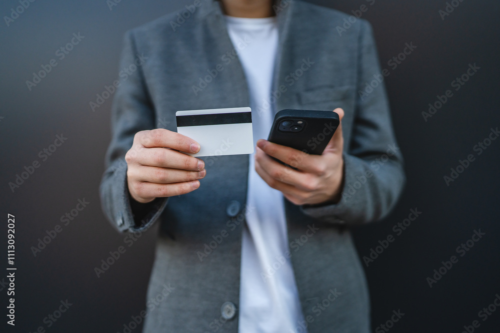 Close up of adult man shop online on mobile phone with credit card Close up of adult man shop online on mobile phone with credit card