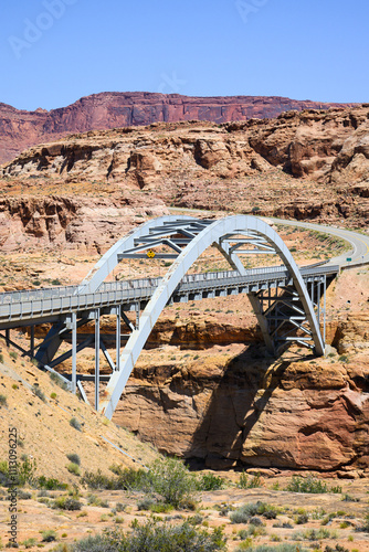 Arched Hite Crossing Bridge in canyon country of Utah with highway photo