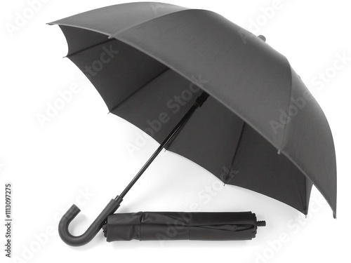 A compact, foldable umbrella in matte black with a rubber handle, fully closed and lying flat on a white background.