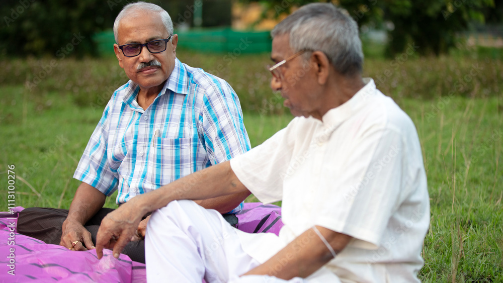 Two aged persons speaking and making interactions at outdoors Two aged persons speaking and making interactions at outdoors