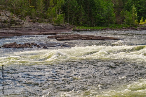 Rushing Mountain River with Foaming Rapids and Rocks – A Dramatic Display of Nature’s Power