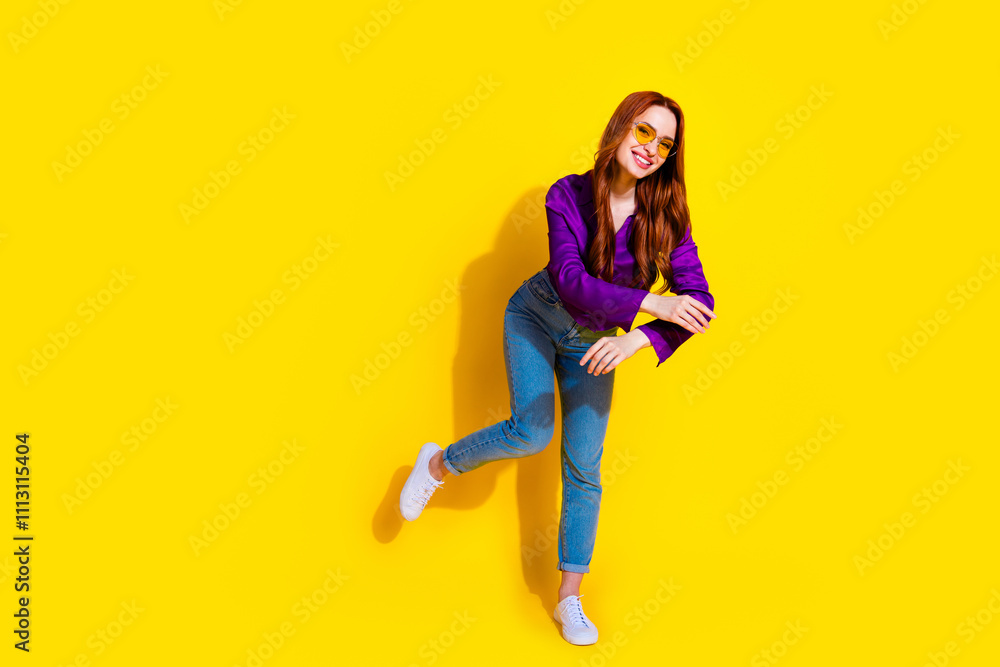 Full size photo of attractive young woman sunglass dancing dressed stylish violet clothes isolated on yellow color background Full size photo of attractive young woman sunglass dancing dressed stylish violet clothes isolated on yellow color background