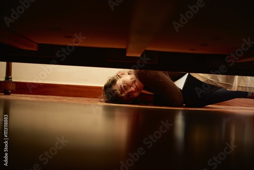 A mysterious encounter under the wooden bed photo