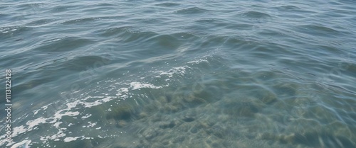 Calm sea surface with tiny white splashes and subtle ripples , ocean, gentle