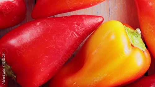 Top View of Vibrant Red, Yellow and Orange Bell Peppers on Wooden Table