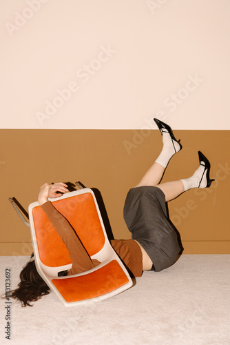 Funny Moment of Woman Tripping Over Orange Chair