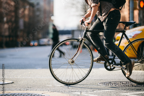 City Commuter Riding a Bicycle in Urban Traffic