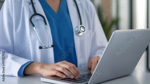 Healthcare worker conducting telemedicine consultation, wearing white coat and stethoscope, focused on laptop.