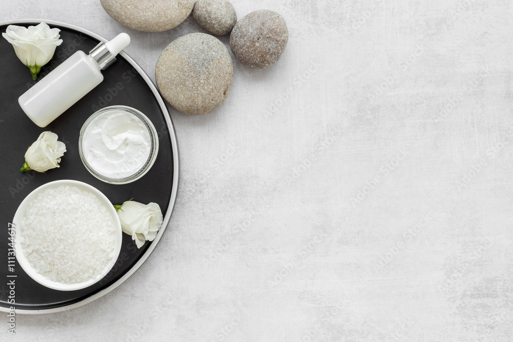 Spa set with cosmetic products with white flowers, top view Spa set with cosmetic products with white flowers, top view