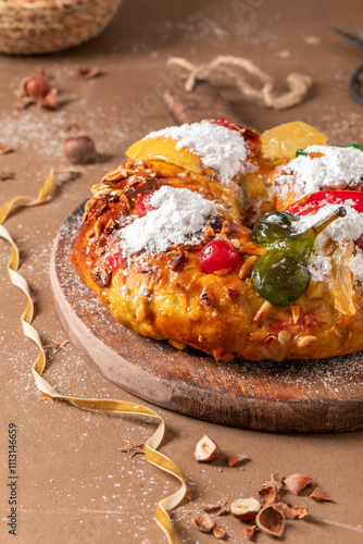 Bolo do Rei or King s Cake, Made for Christmas, Carnavale or Mardi Gras with Christmas season elements in Background. photo