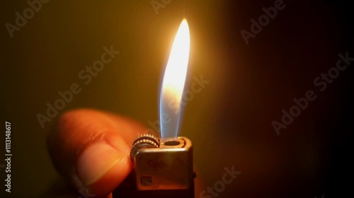 Hand ignite cigarette lighter in dark room, close up, Full HD video, cinematic.