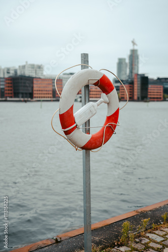 Lifebuoy on the urban waterfront near canal photo