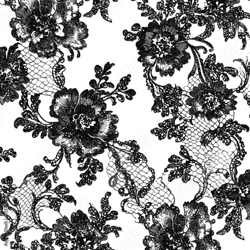 Seamless pattern of black floral lace on white background.
