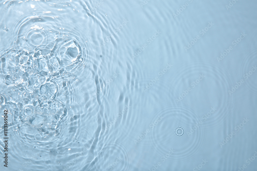 Rippled surface of clear water on light grey background, top view Rippled surface of clear water on light grey background, top view