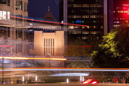 Εκτύπωση καμβά Night time traffic streams by skyscrapers and historic buildings of downtown Los Angeles, California, USA