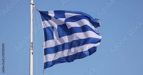 Slow motion video of the Greek flag waving in Athens over the Acropolis