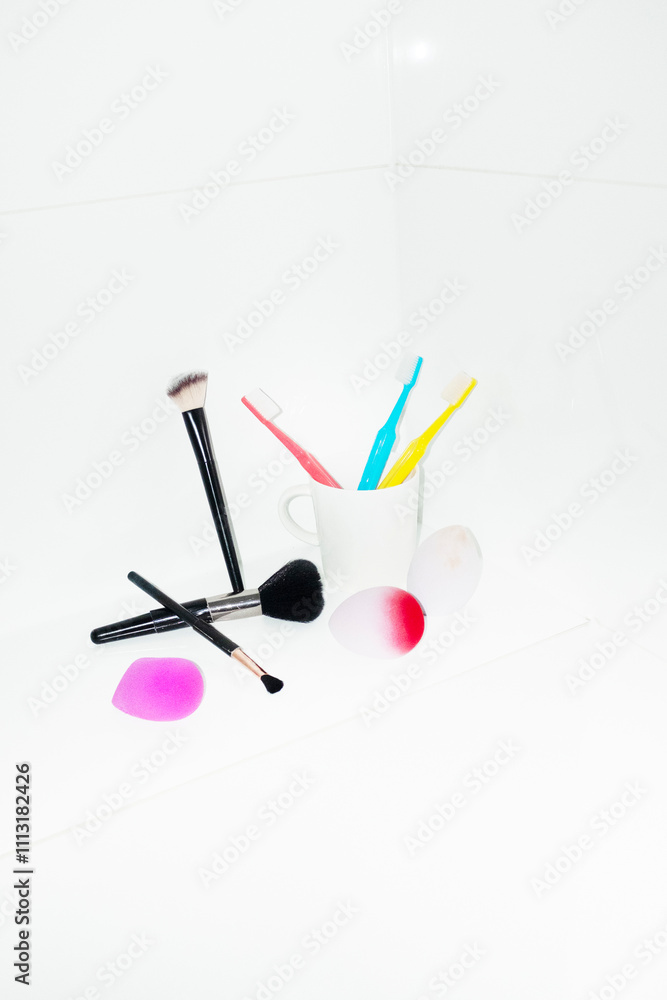 Make-up essentials: sponges, brushes, liners on toilet with flashlight Make-up essentials: sponges, brushes, liners on toilet with flashlight