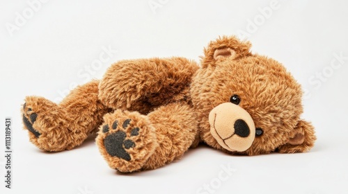 A plush teddy bear lying on its stomach with a soft, fluffy texture and cute facial features.