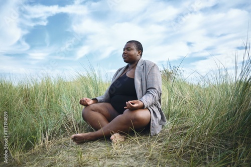 Mindful meditation on a tranquil beach at sunset photo