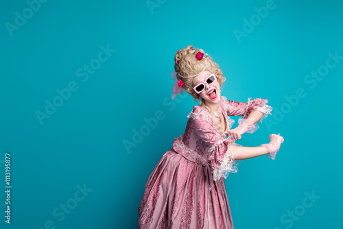 Portrait of young princess girl dance empty space wear vintage dress isolated on turquoise color background photo