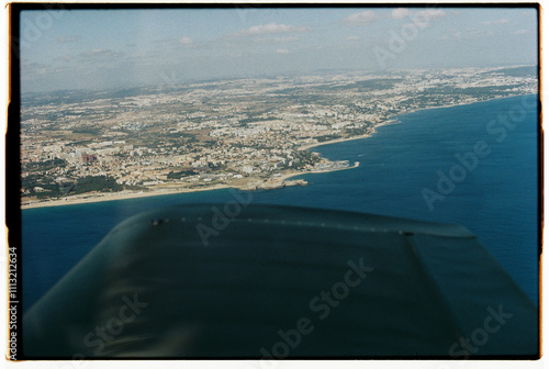 Film view of Costa da Caparica, Portugal from a two-seat airplane photo