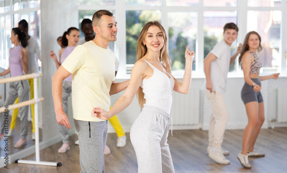 Fototapeta premium Group of different nationalities people learning swing steps at dance class
