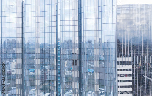 Glass Building Reflecting Urban Cityscape with Distorted Patterns photo