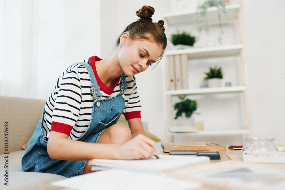 Happy Teenage Girl Painting in her Modern Art Studio, Surrounded by Colorful Artwork and Creative Tools Happy Teenage Girl Painting in her Modern Art Studio, Surrounded by Colorful Artwork and Creative Tools