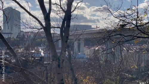 Wallpaper Mural Winter or autumn view with bare trees, buildings, a bridge, and structures in the background in European city.  Torontodigital.ca